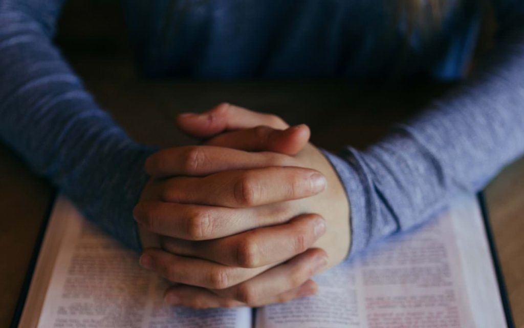 Hands clasped in prayer