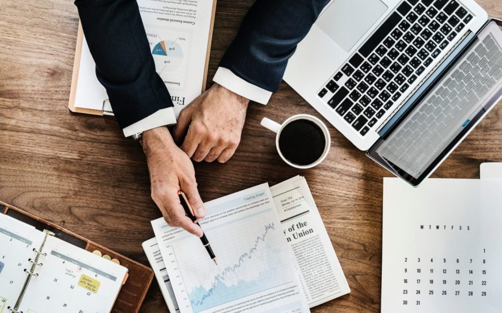 Financial statements and computer on desk