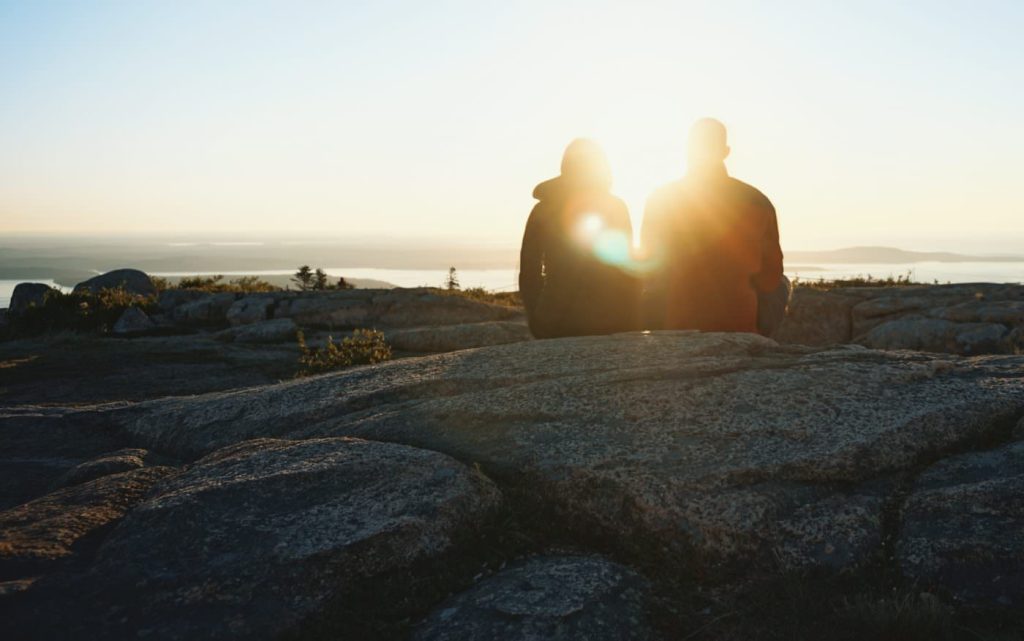 Friends talking on a cliff by the ocean