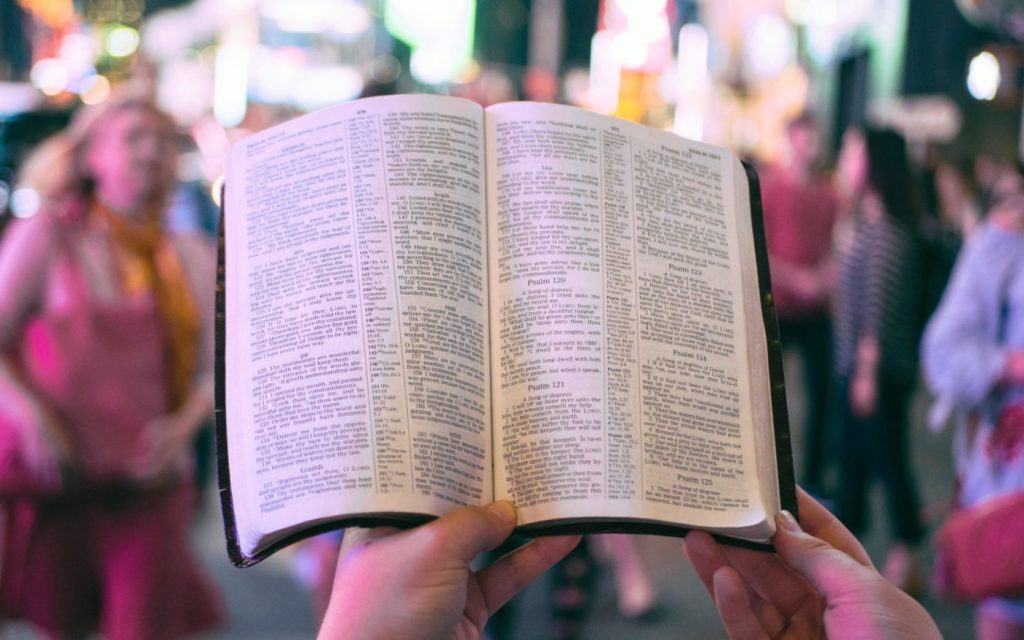 Bible held up in a crowd
